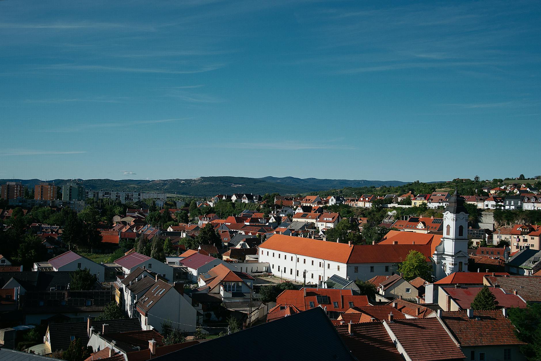 Panorama węgierskiego miasteczka z czerwonymi dachami i błękitnym niebem