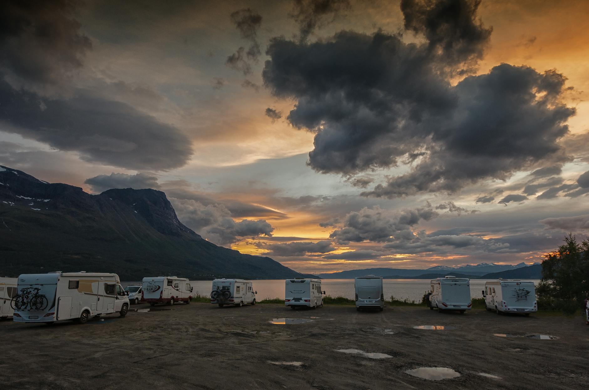Zachód słońca nad norweskim kempingiem z kamperami na Lofotach Zachód słońca nad norweskim kempingiem z kamperami na Lofotach